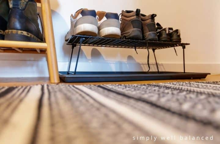 Organize Kids Shoes | Kids shoes on rack in mudroom.