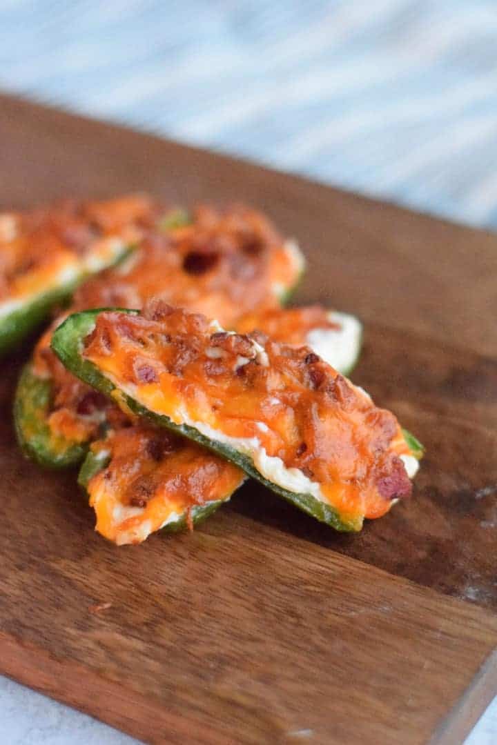 finished Ninja Foodi jalapeno poppers on a wooden cutting board
