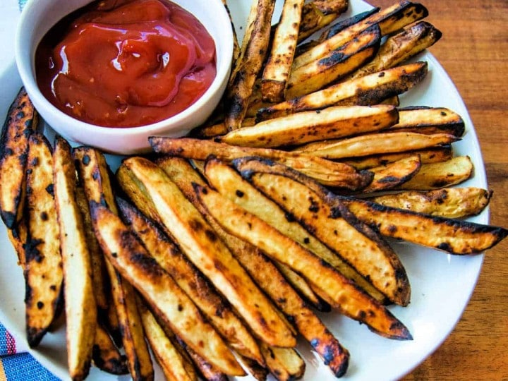 Grilled French Fries on a plate with Spicy Ketchup in a small bowl