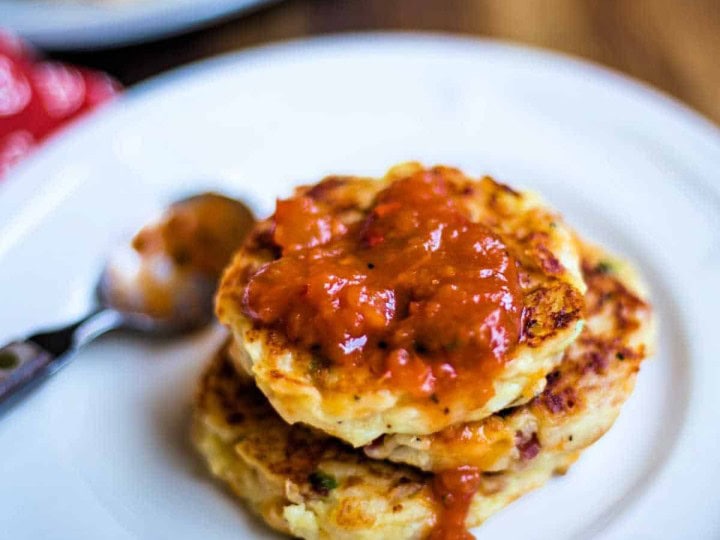 Tex-Mex mashed potato cakes with salsa on a white plate