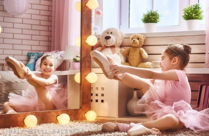 Gifts for girls who love to dance. Little girl looking in mirror trying on new ballet shoes