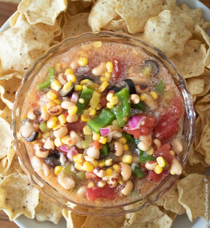 bowl of redneck caviar on a plate with tortilla chips