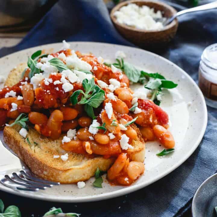 Instant Pot tomato white beans are made in a fraction of the time by using a pressure cooker. It's a hearty winter meal perfect over some toasted sourdough bread.
