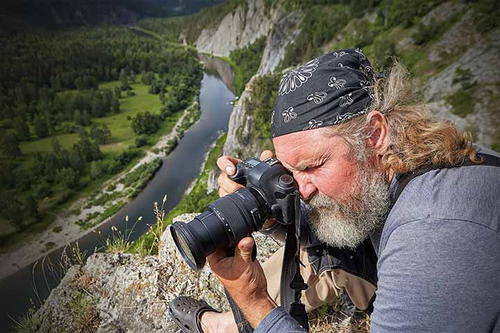 Man photographing valley