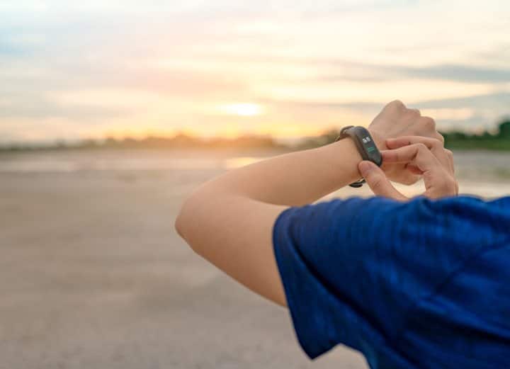 Person checking fitness on Fitbit smartwatch