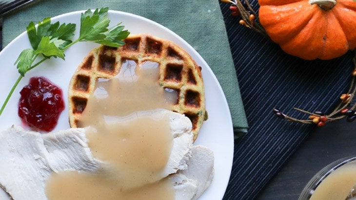 Low Carb Stuffing Chaffle on a plate with turkey and gravy by themerchantbaker.com