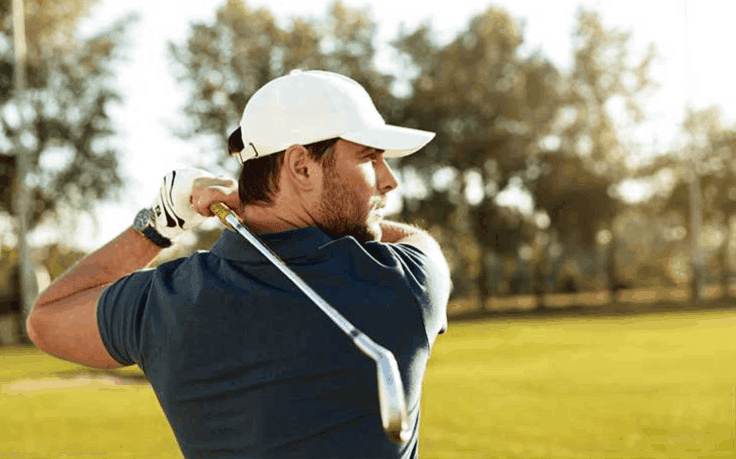 A young man is playing golf