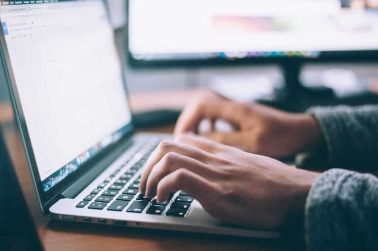 Content writer, doing writing on a laptop.