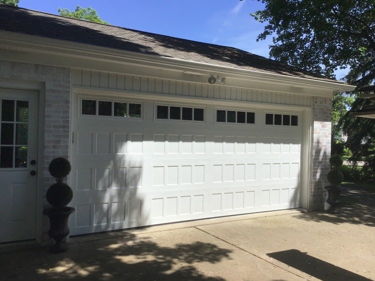 alt="south lyon garage door install. Safe-way double door in white"