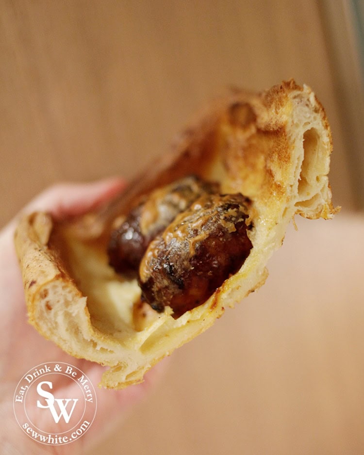 Easy Toad in the Hole cross section of the batter and sausages. Dissection of food.