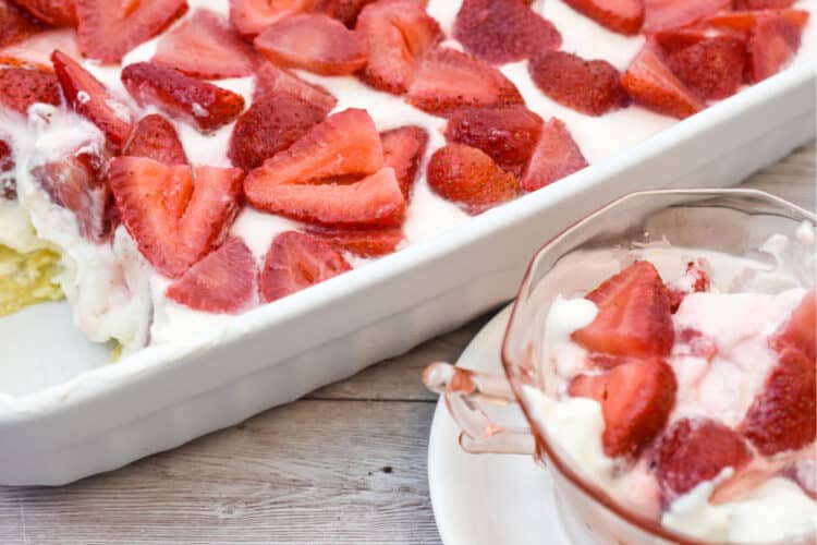 It's a picture of no bake keto cheesecake made in a rectangle pan topped with fresh strawberries