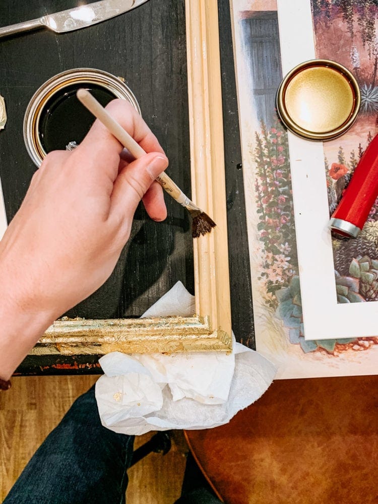Woman's hand applying a gold leaf finish