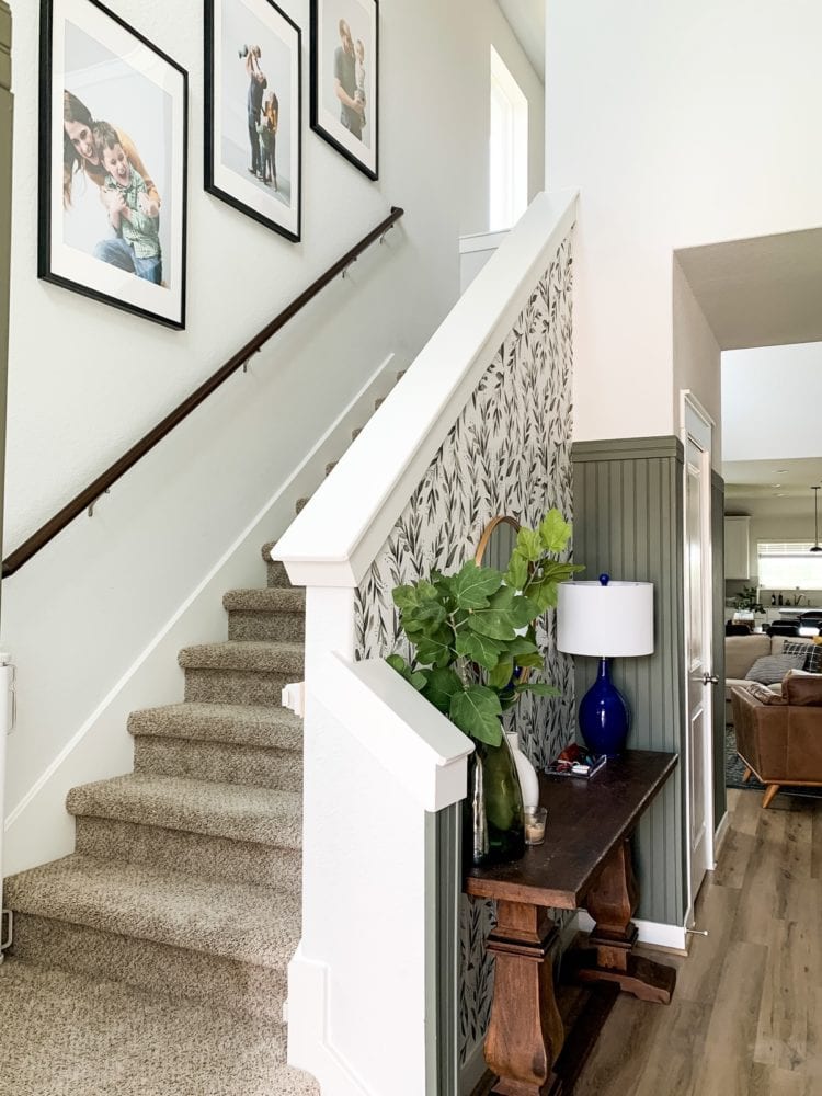 Entryway with photos going up staircase