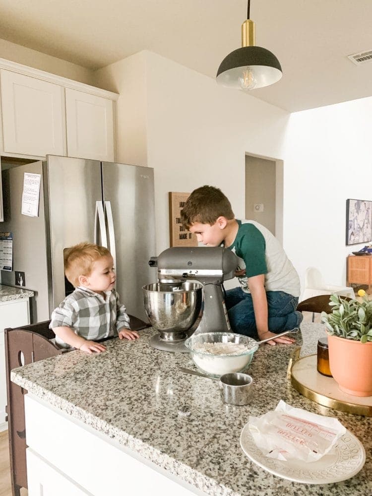 two young boys baking cookies