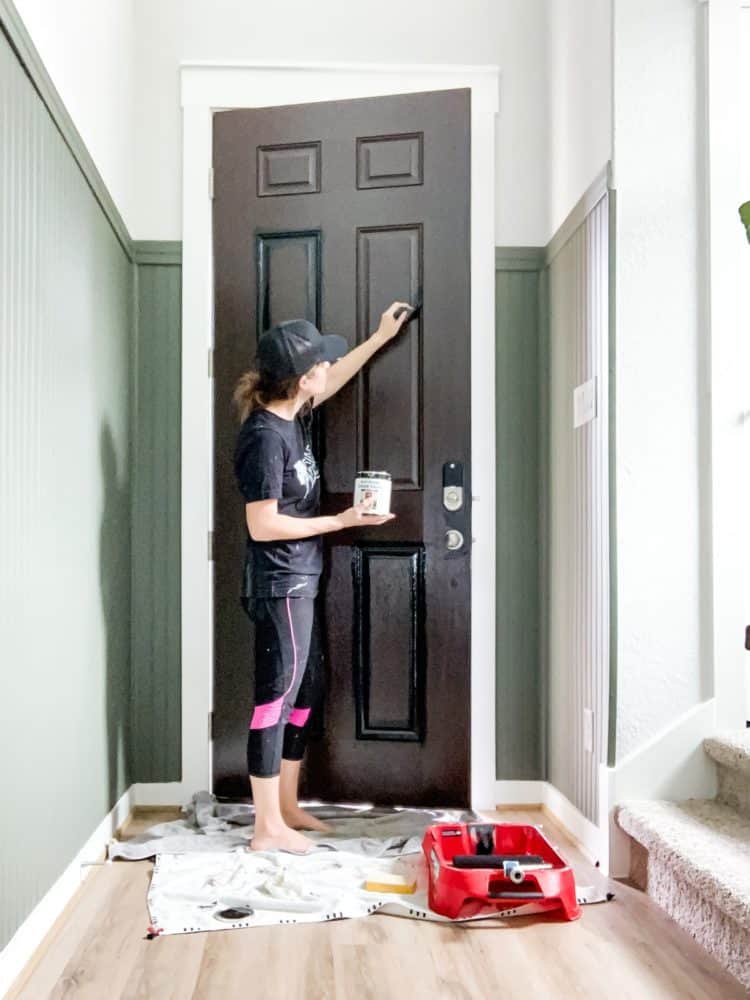 Woman painting a front door