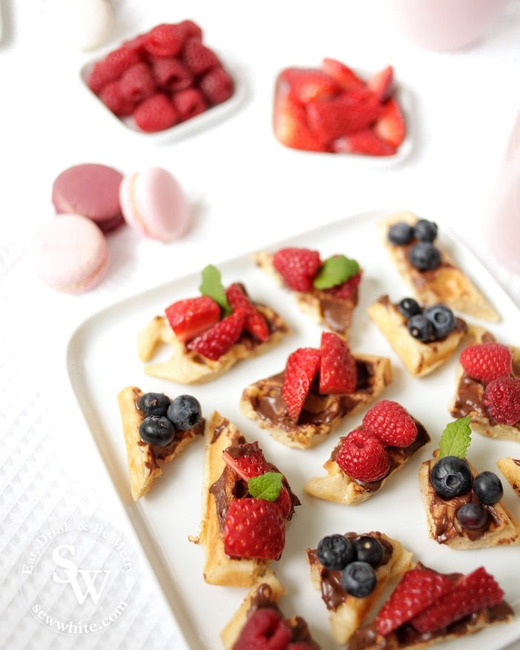 Bright summer berries on golden brown buttermilk waffle with bright red fresh berries. From the recipe Afternoon tea waffle bites by Sew White