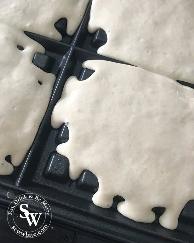 Making the waffles for the Afternoon Tea Waffle Bites in a waffle iron.