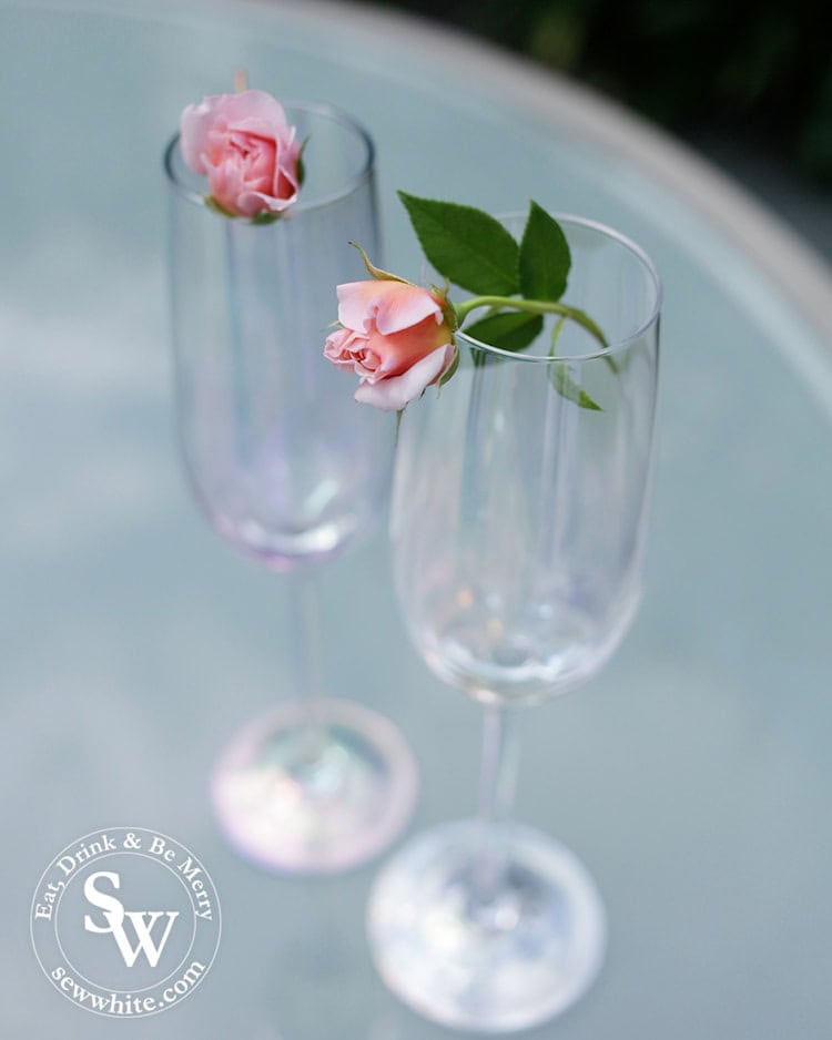 delicate roses balanced on champagne glasses for the prosecco cocktail with rose and elderflower