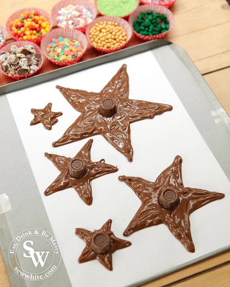 Getting ready to decorate the christmas star chocolates with sprinkles.