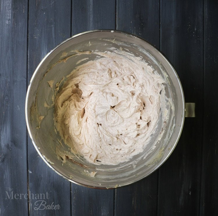 An overhead view of batter in a bowl to make Brown Sugar Cinnamon Whipped Cream Cream Cheese Frosting by themerchantbaker.com