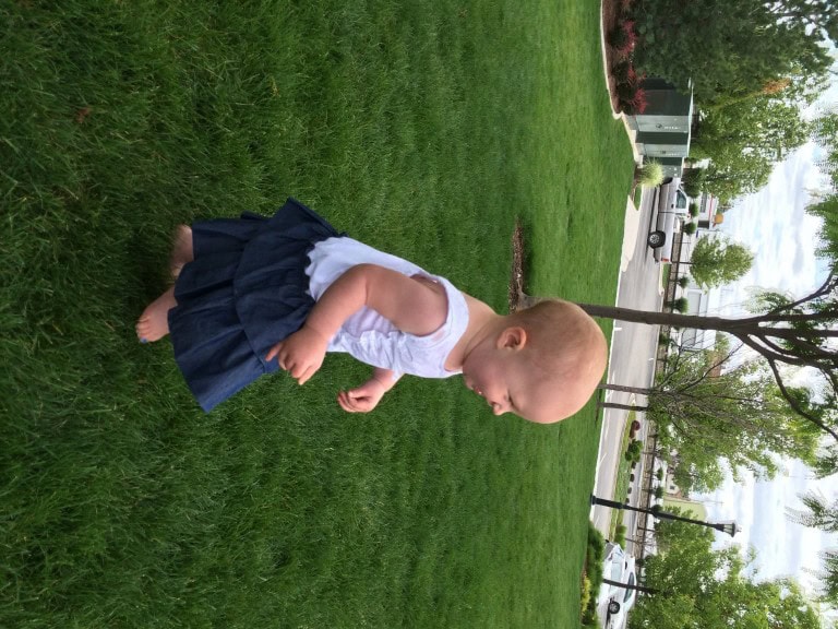 Hazel playing soccer at the family photo op with her blue and white (colors requested) WAY too big dress!