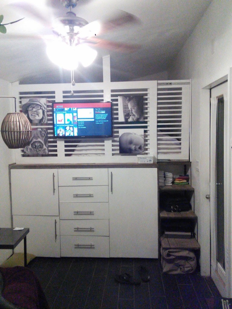 I moved my tv and mounted it on this wall, along with some family photos. The gate is hug with some heavy duty drawer rollers