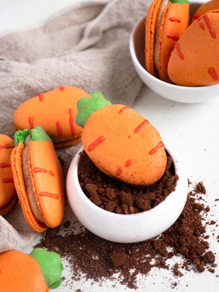 Carrot shaped macarons filled with carrot cake cream cheese buttercream easter cookies