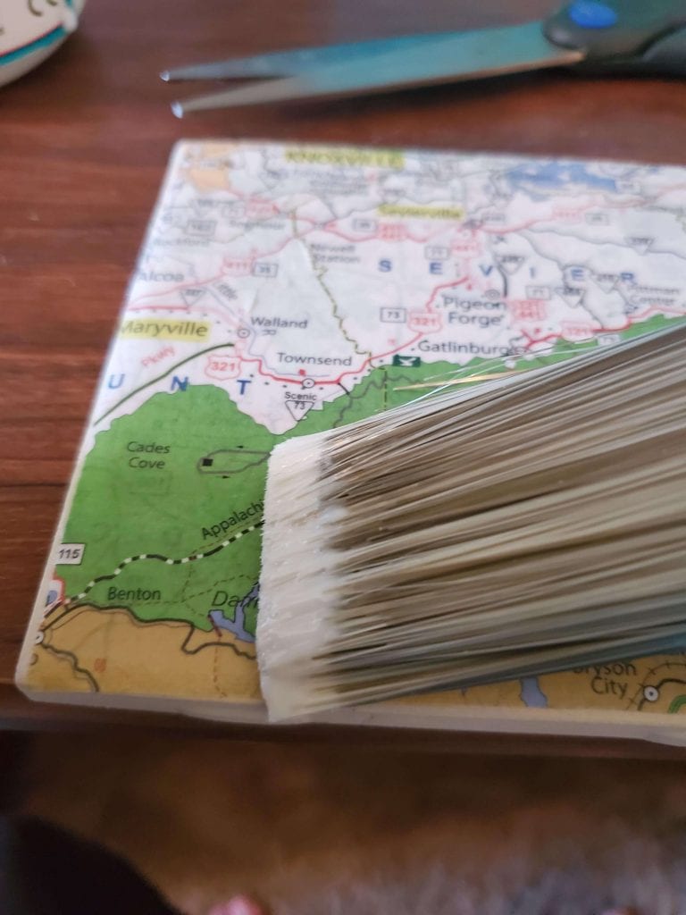 Map coaster being brushed with clear mod podge.