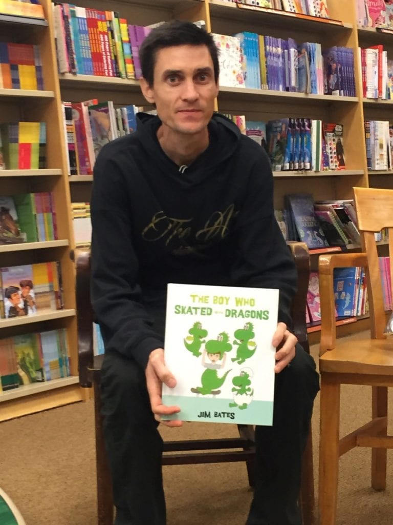 Jim Bates holding his book