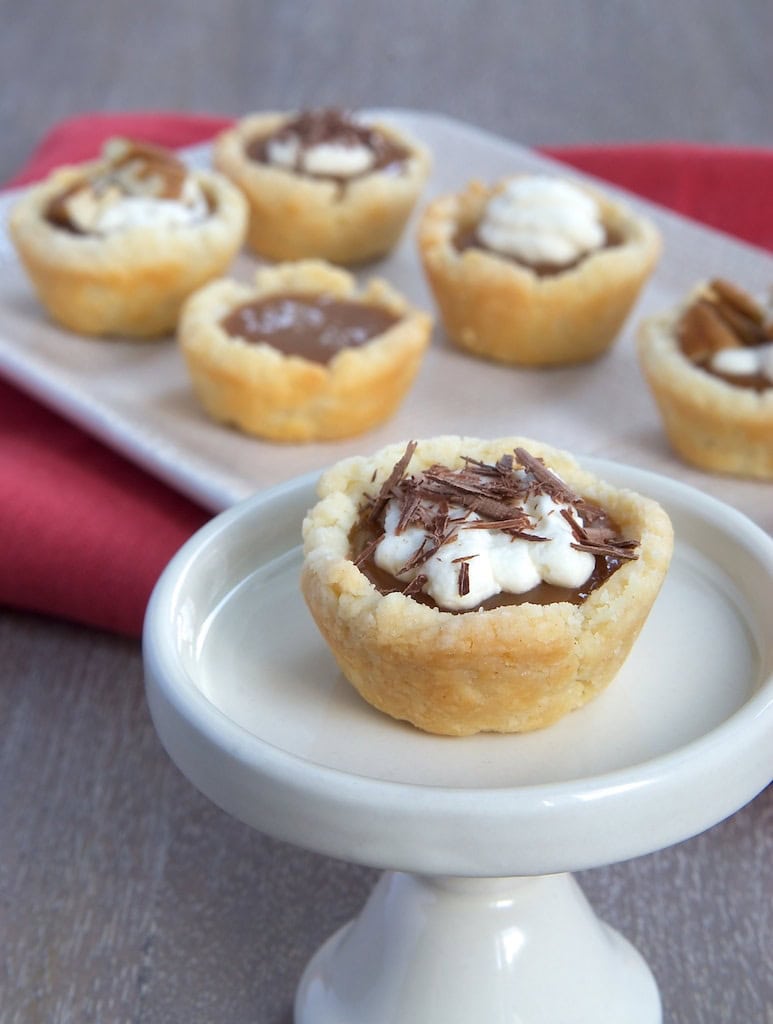 Mini Caramel Tarts combine a cream cheese crust with a rich caramel filling that can be topped with whipped cream, salt, chocolate, or your favorite topping. - Bake or Break