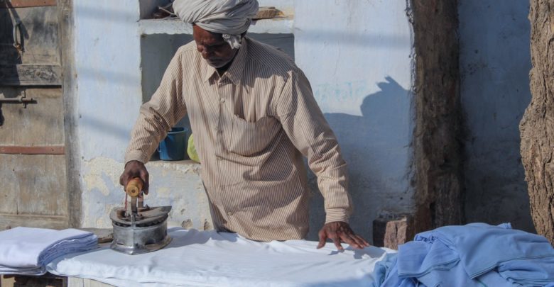 Man ironing using old Iron