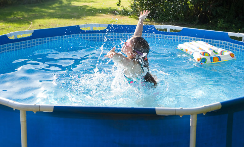 Child having fun in rubber swimming pool.