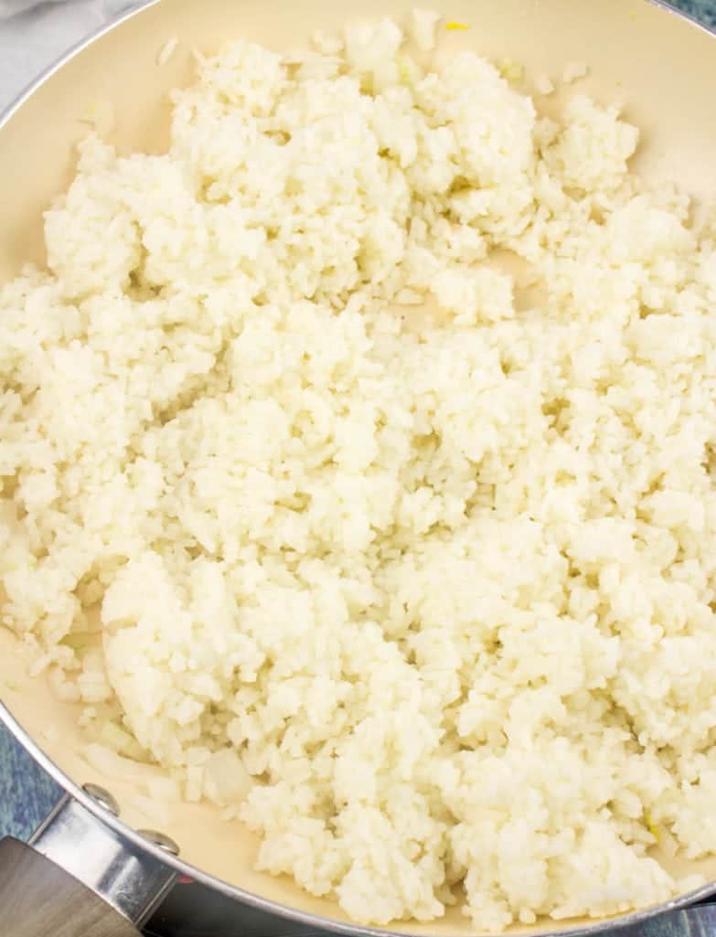 cooked white rice in a large skillet along with diced onions