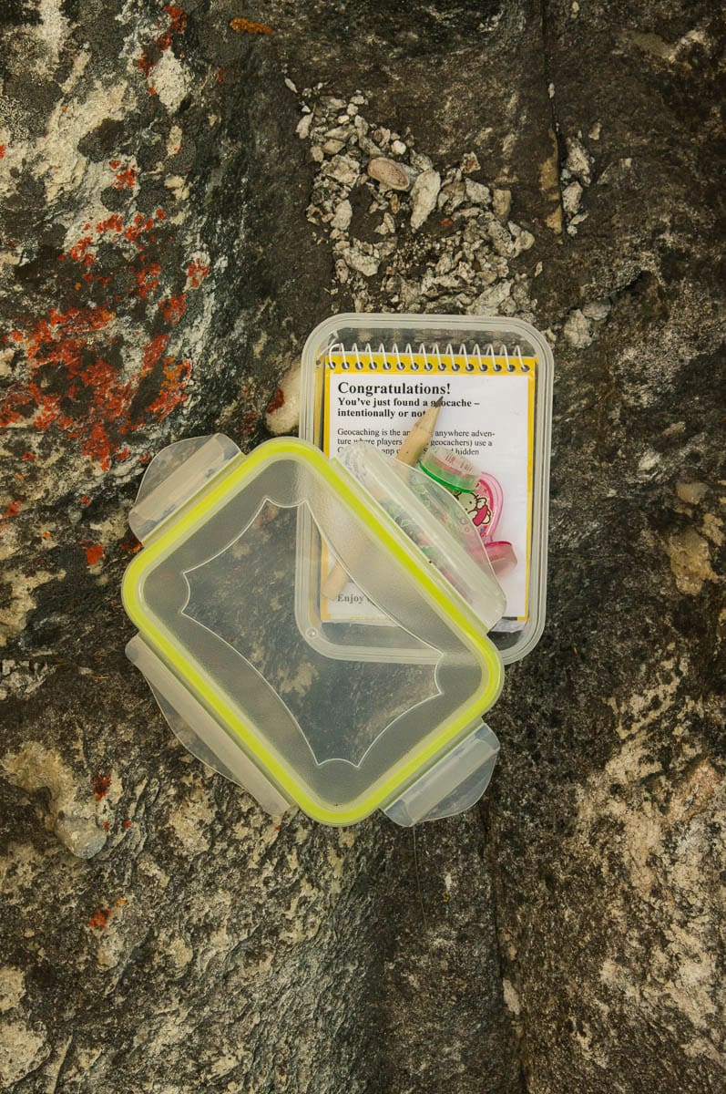 Geocache box with notebook and treasure