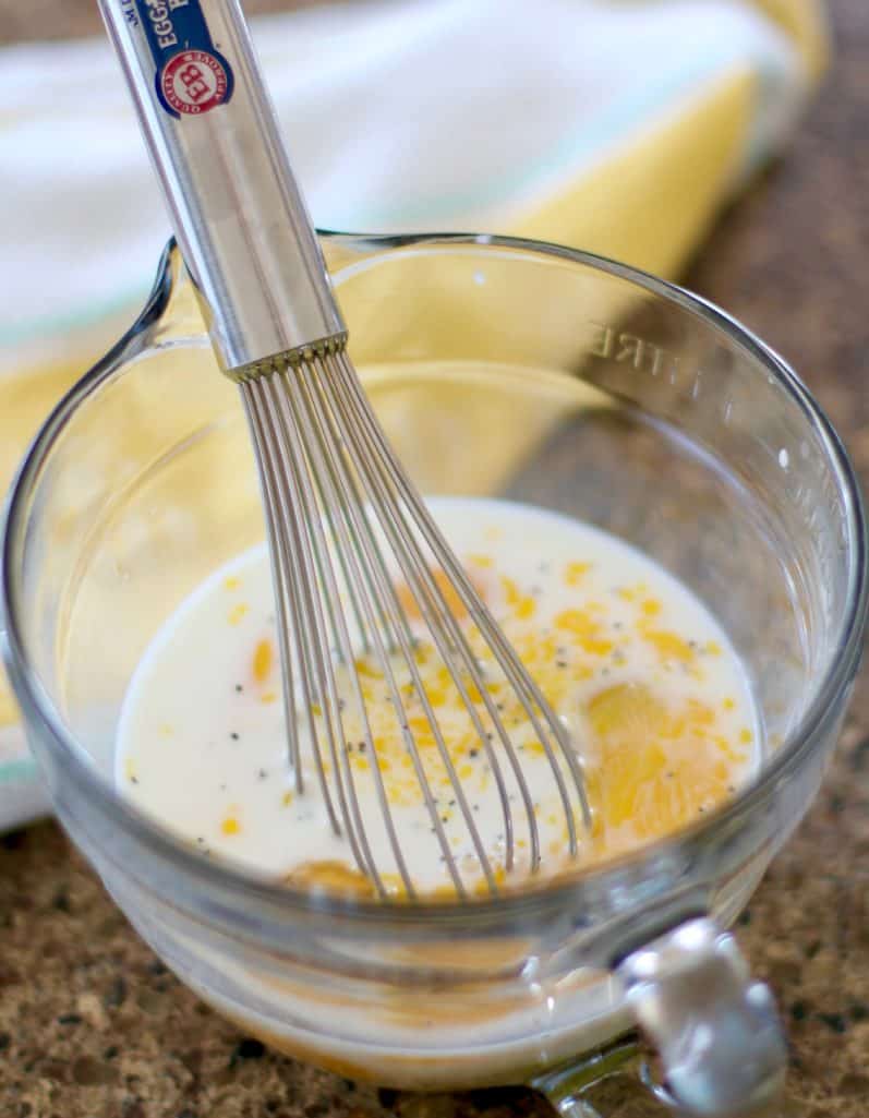 eggs, milk, salt and pepper whisked together in a Pampered Chef glass measuring cup bowl