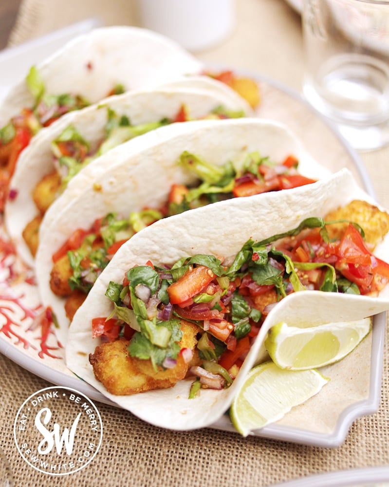 Tomato and lettuce salsa with red onion on top of fish fingers for a fish finger burrito