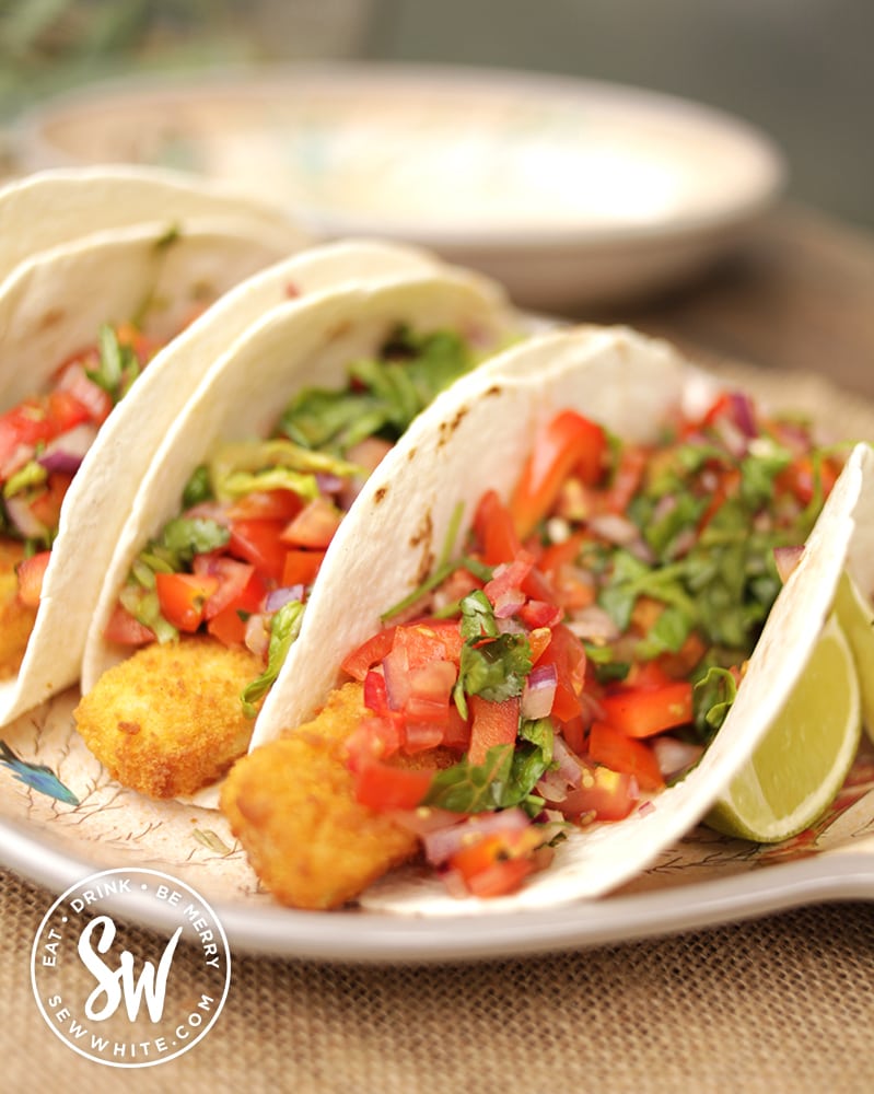 fish finger wraps with fresh lime slices and hot chilli salsa to serve alongside.