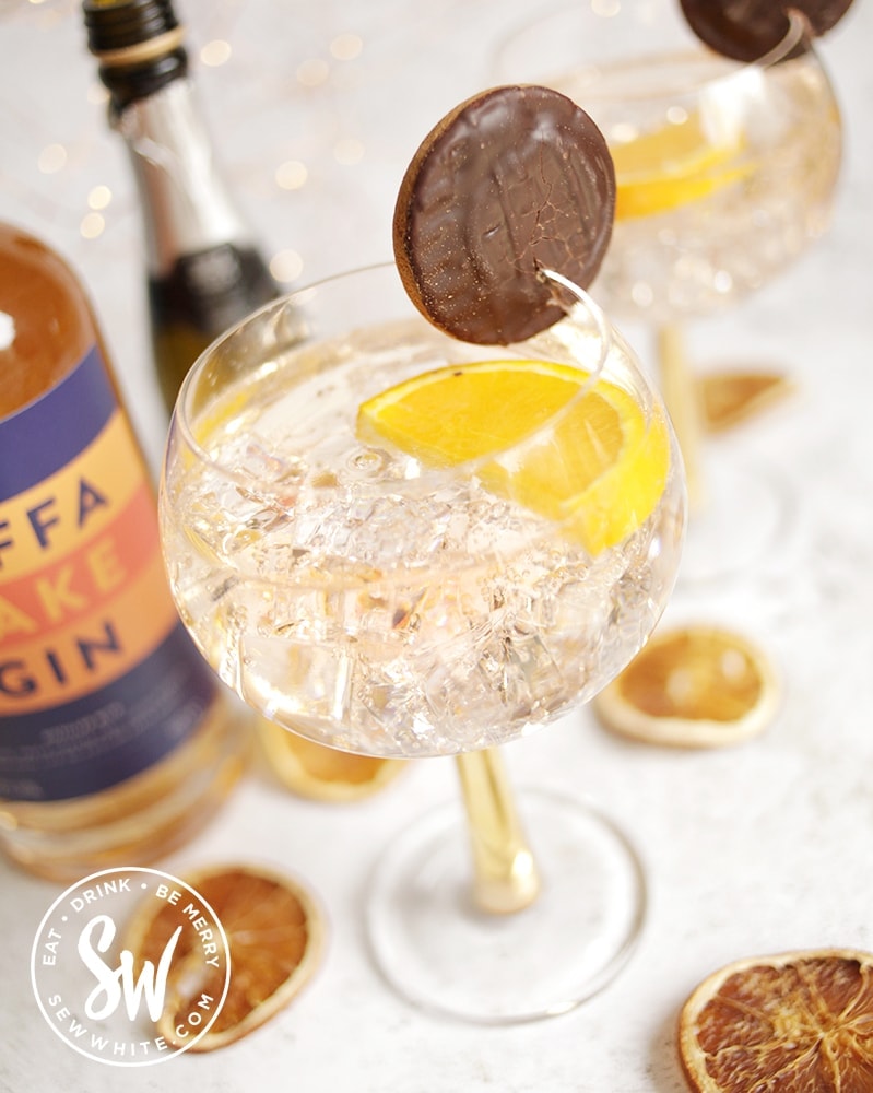 Jaffa Cake Gin Spritz decorated with a slice of orange and a jaffa cake