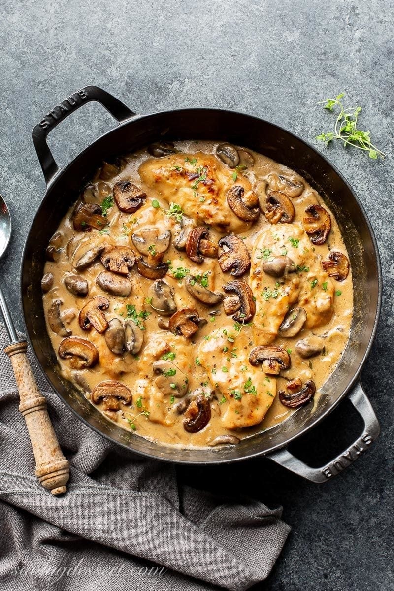 A skillet with chook and mushrooms with contemporary thyme