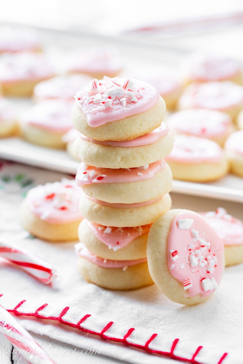 A stack of buttery Peppermint Meltaway Cookies with crushed peppermint candy on top