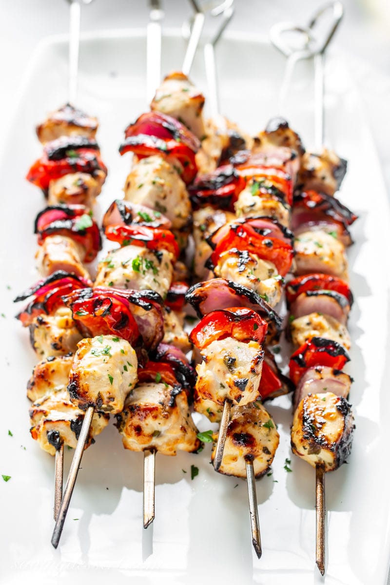 Grilled Greek Chicken skewers with purple onion and red peppers