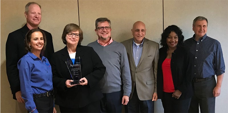 Susan Ryba accepts the Walter R. McGrath Executive Consultant of the Year Award.
