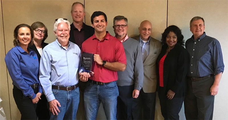 Robbie Tugwell (left) and Philip Zicarelli accept the 2019 Partner of the Year Award on behalf of PowerSecure from the Hometown staff.
