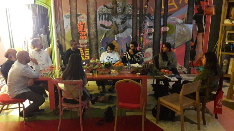 RRH's Studio-House in Dubai with a group of artists and curators around the table discussing a project