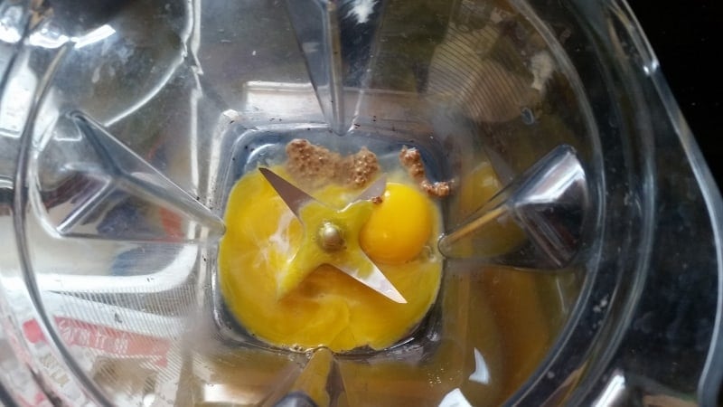 image of egg yokes, mustard and lemon juice in blender