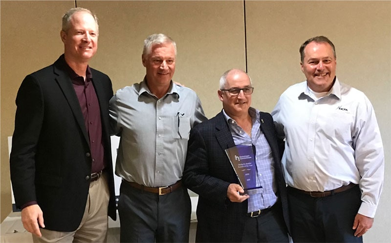 Loreto Sarracini (right) and Doug Westlund accept the Partner of the Year Award on behalf of AESI-US, Inc.