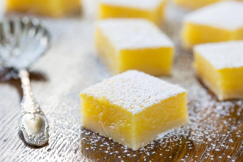 Tangy Lemon Bars ~ Tangy, tart, sweet, and creamy, with an incredible texture and a delicious shortbread crust. These bars are absolutely amazing! www.savingdessert.com