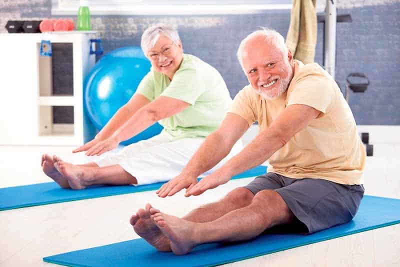 Elder couple has a training for back in the gym