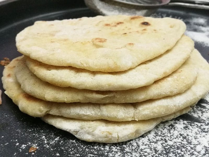 My recipe for no-knead 4 ingredient pita is super easy to make and budget-friendly too. Made using just 4 basic ingredients, you can have soft fluffy pitas on your table in under 40 minutes. Perfect for sandwiches, wraps or just a pizza base, this is one amazing recipe. 4 ingredient Pita (No knead)