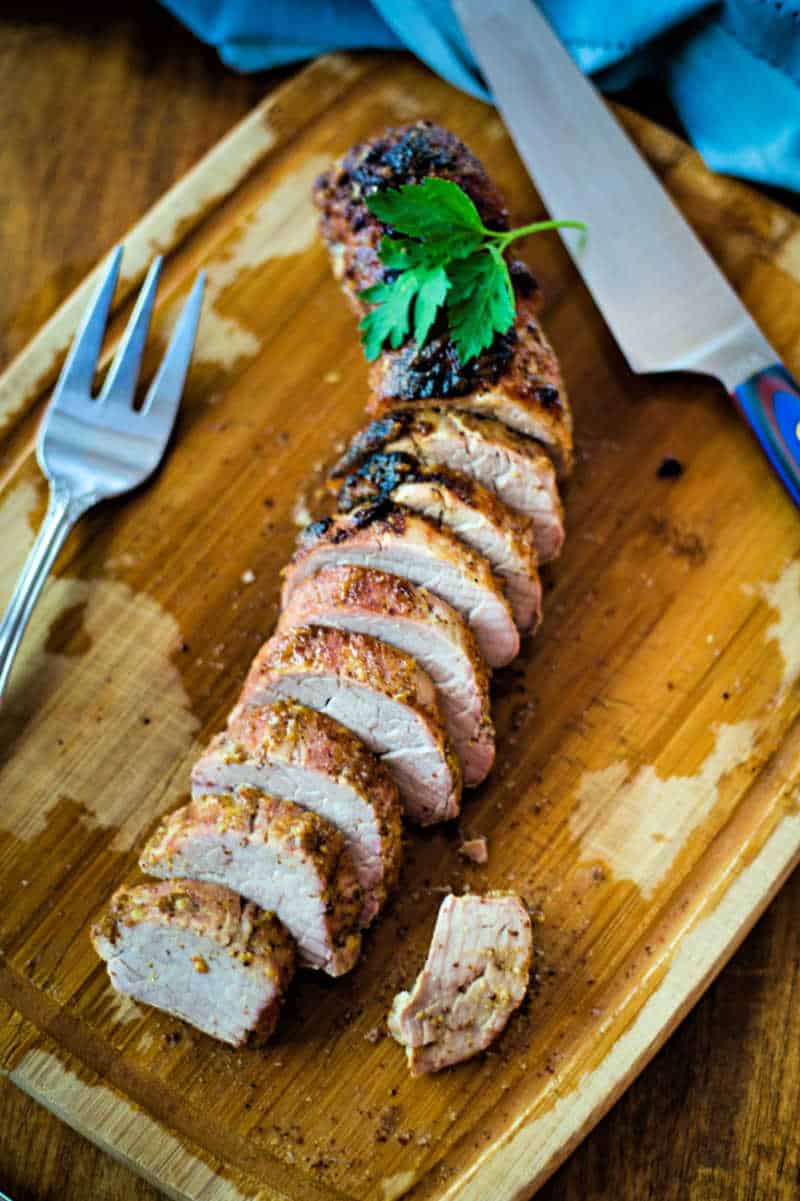 Maple Dijon Oven-Roasted Pork Tenderloin on a a cutting board